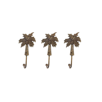 Three palm tree-shaped wall hooks on a white background