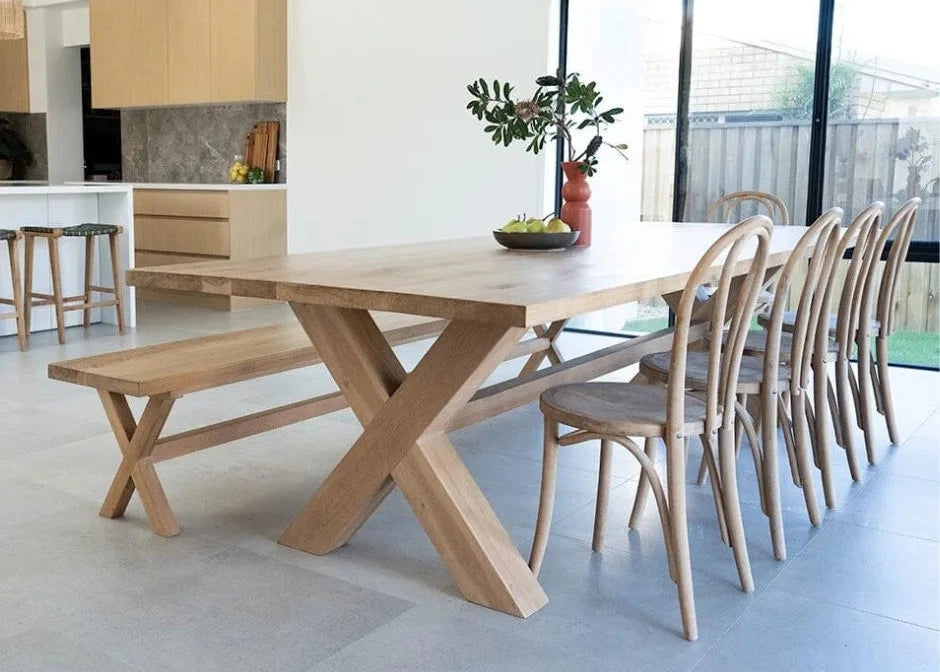 Modern dining area with wooden table and chairs in a bright room.
