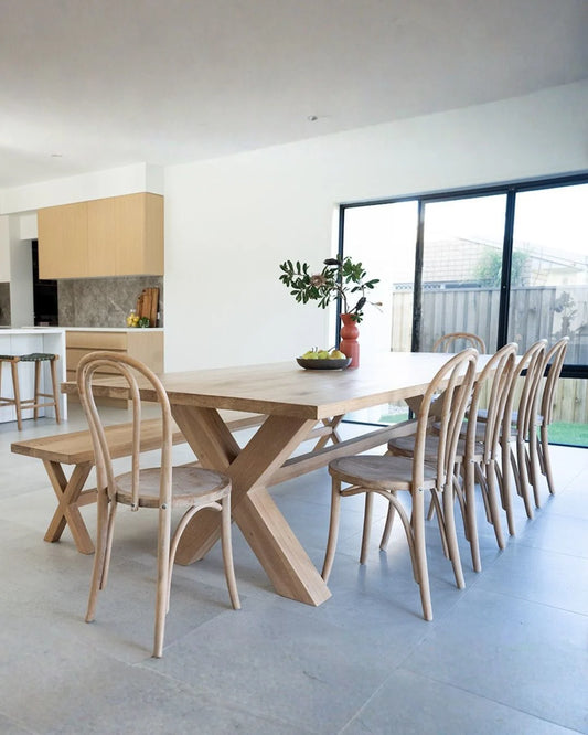 Wooden dining table with chairs in a modern kitchen setting