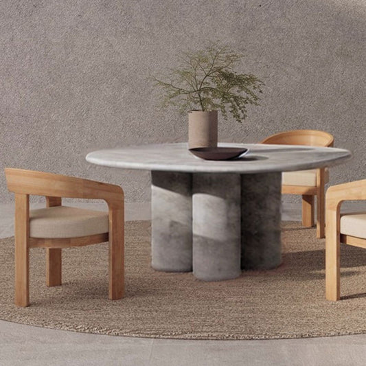 Dining table with chairs against a textured wall