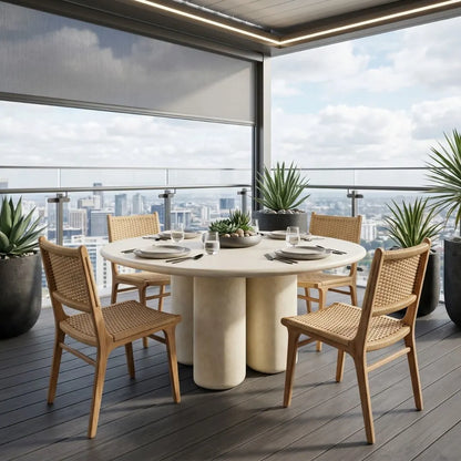 Dining table set with chairs on a balcony with cityscape view
