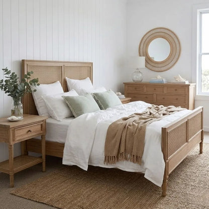 Bedroom with wooden bed and matching nightstands, featuring a round mirror on the wall.