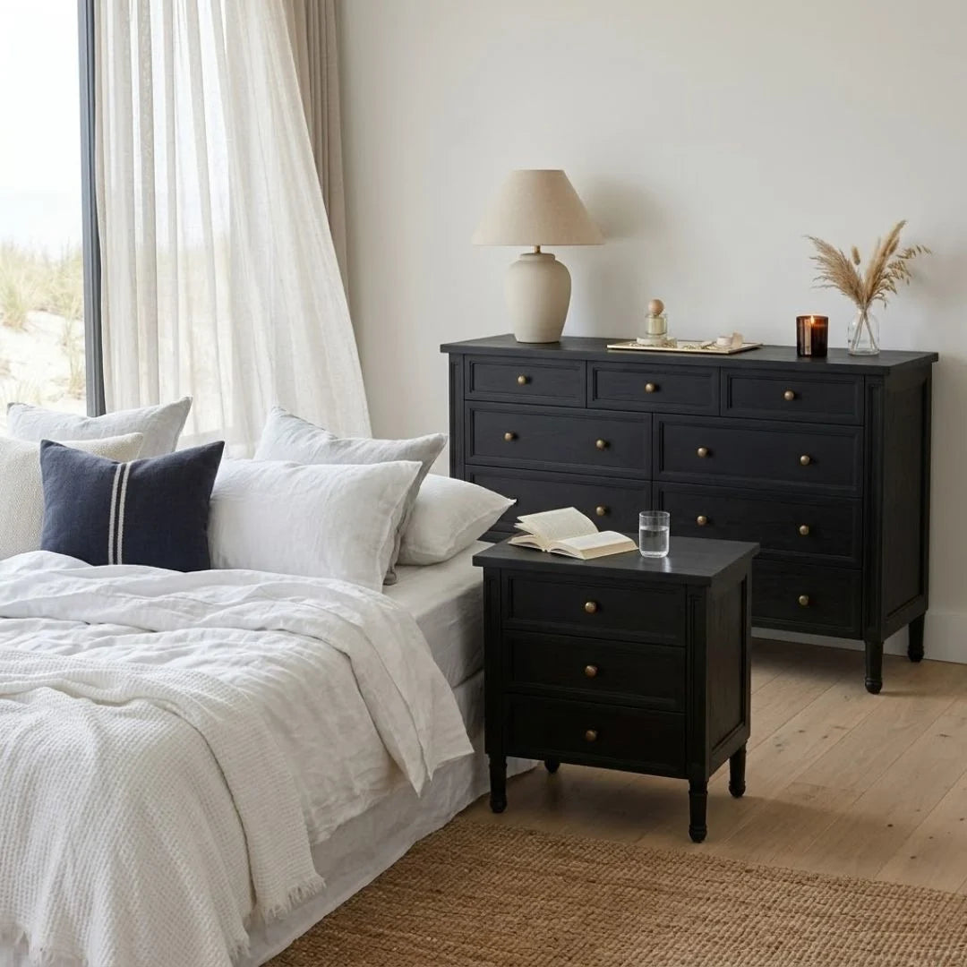 Neatly arranged bedroom with a bed, nightstand, and dresser.