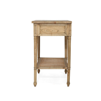 A rustic light brown wooden side table with a single drawer, open lower shelf, and turned legs, shown against a plain white background.