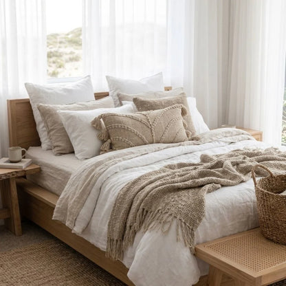 Chloe Cushion Cover on a styled modern coastal bed.