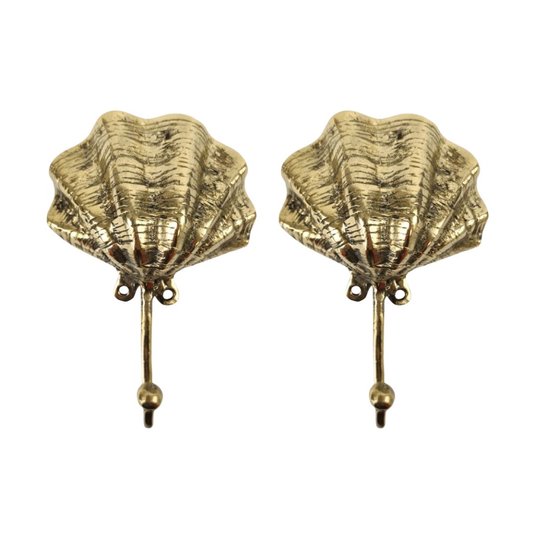 Pair of gold shell-shaped earrings on a white background