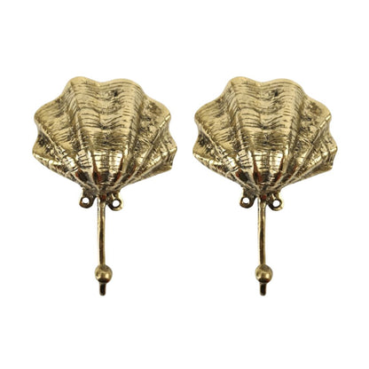 Pair of gold shell-shaped earrings on a white background