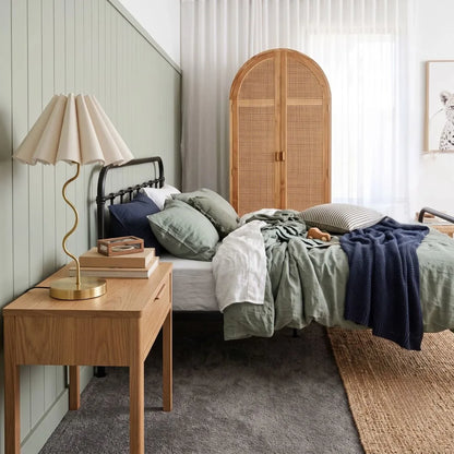Sun Republic gold cora table lamp in a modern bedroom setting styled on timber bedside table
