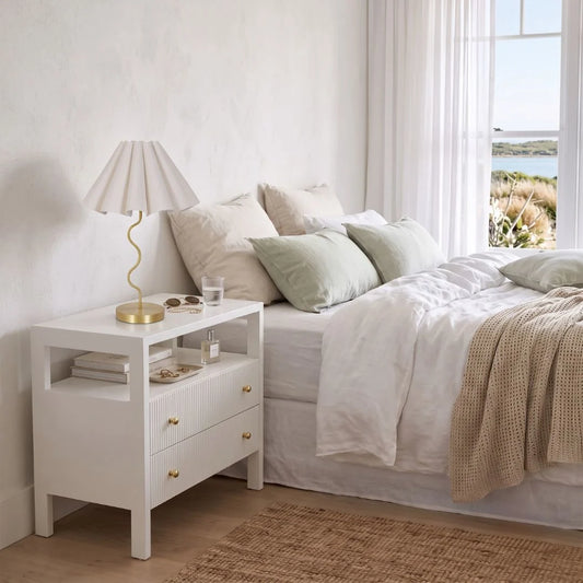 Sun Republic gold cora table lamp in a modern bedroom setting styled on white bedside table