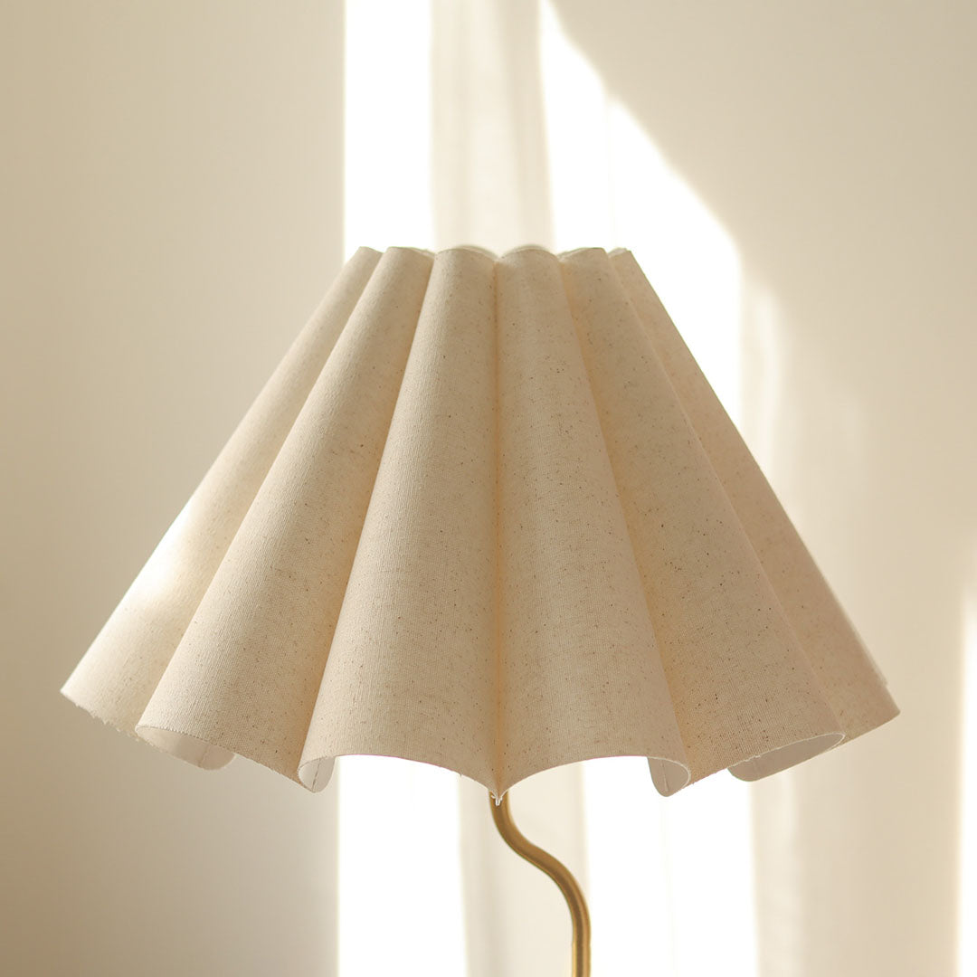 Cora Table lamp with a white pleated shade and gold curved base