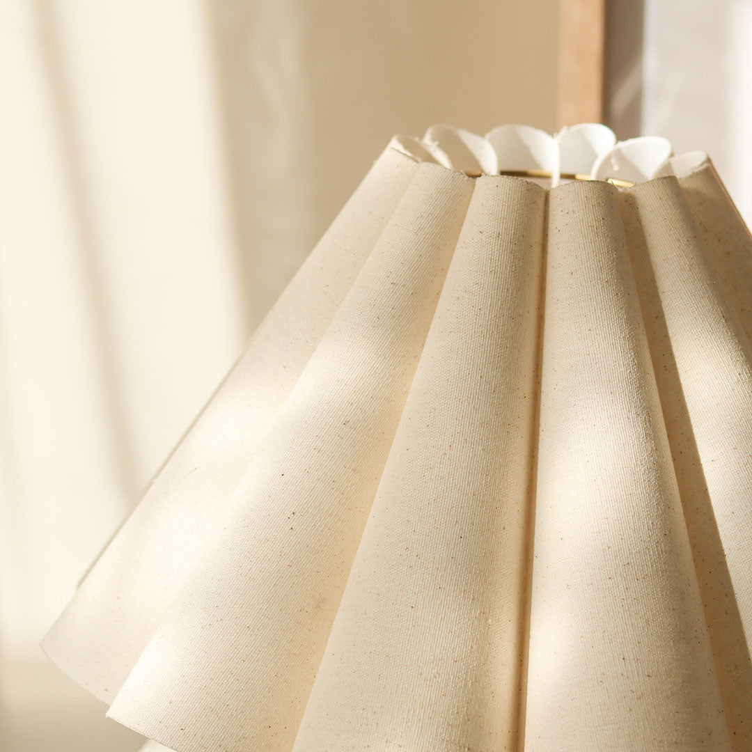 Cora Table lamp with a white pleated shade and gold curved base