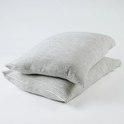 Two white and ink blue pin striped pillows on a white background
