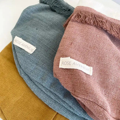 Three textured hats in blue, brown, and pink with 'Rose Avenue' labels on a white background.