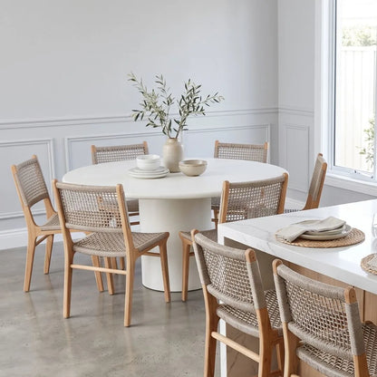 Dining room with round table and chairs in a bright room