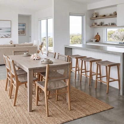 Modern kitchen and dining area with wooden furniture and large windows.