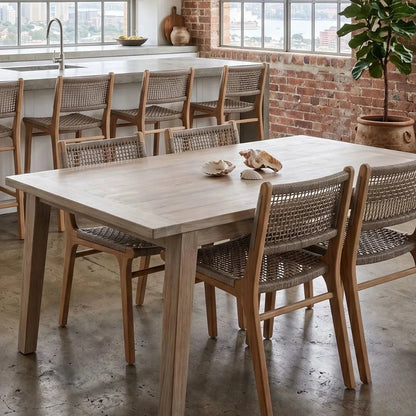 Wooden dining table with chairs in a modern kitchen setting.