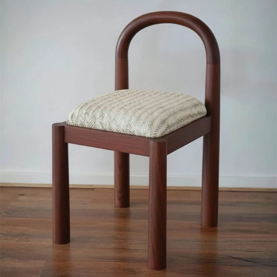 Wooden chair with quilted cushion on a wooden floor
