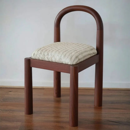 Wooden chair with quilted cushion on a wooden floor