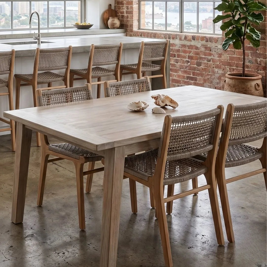 Wooden dining table with chairs in a modern kitchen setting.