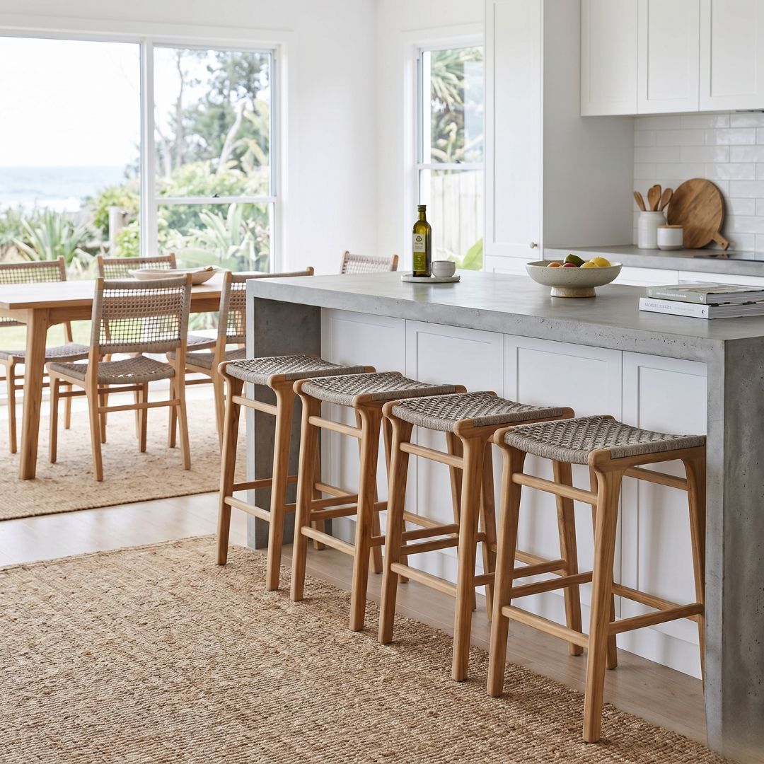 Modern kitchen with bar stools and a dining area