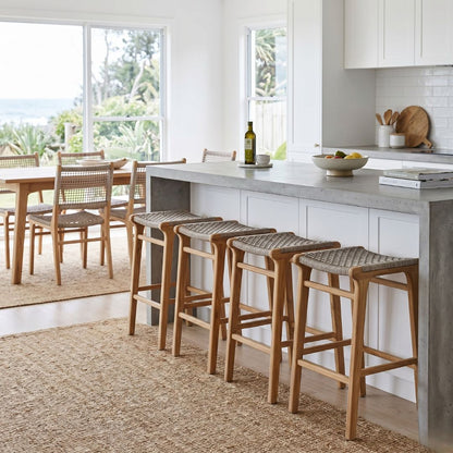 Modern kitchen with bar stools and a dining area