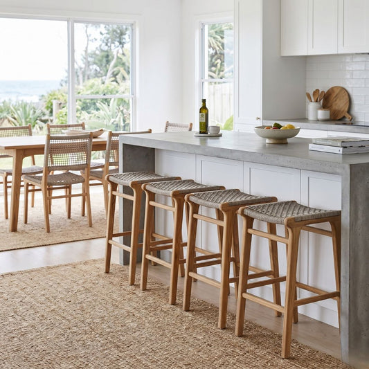 Modern kitchen with bar stools and a dining area