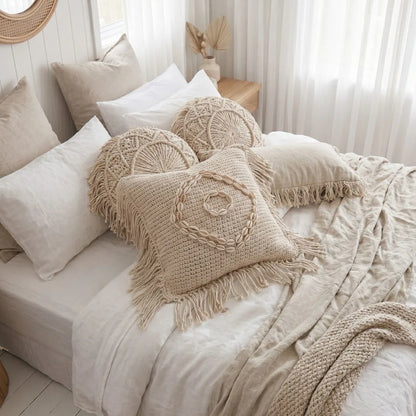 Cozy bedroom with textured pillows and blankets on a bed