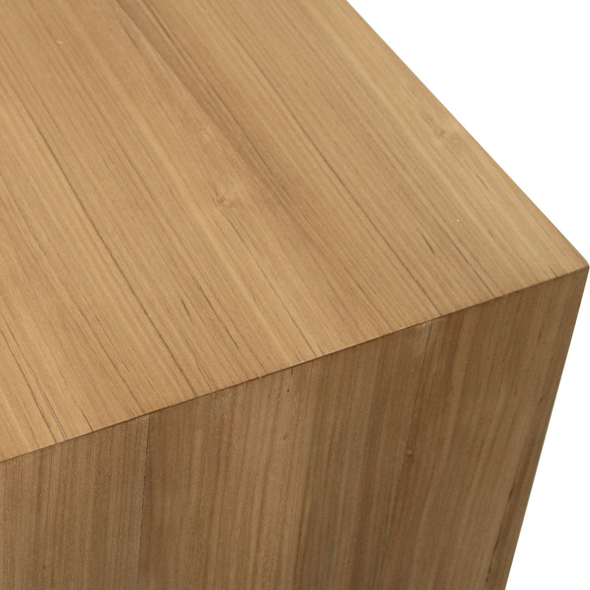 Close-up of a light natural wood surface with visible grain and a clean white background.