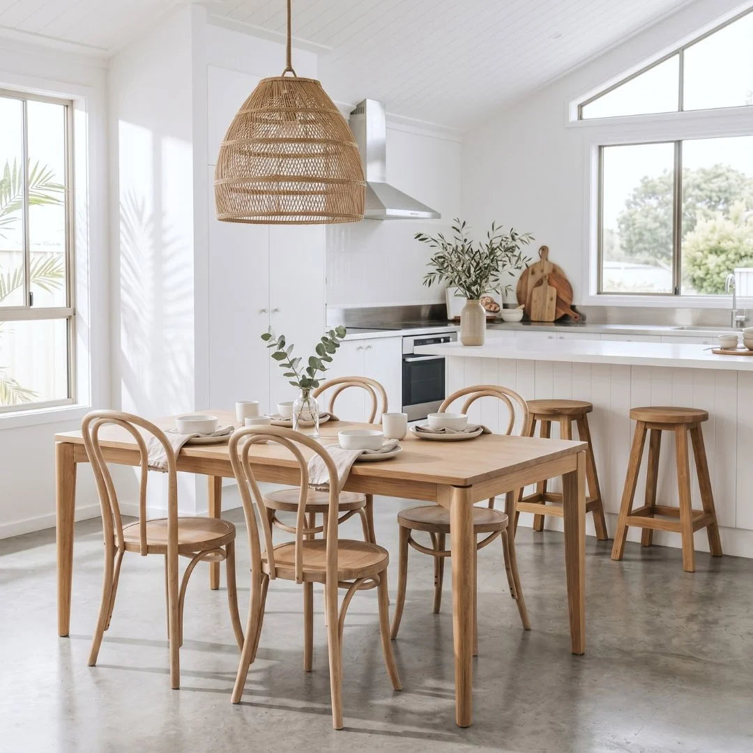 Dining area with wooden table and chairs in a bright kitchen.