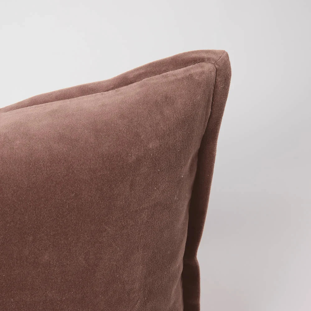 Close-up of a velvet clay coloured extra long lumbar cushion