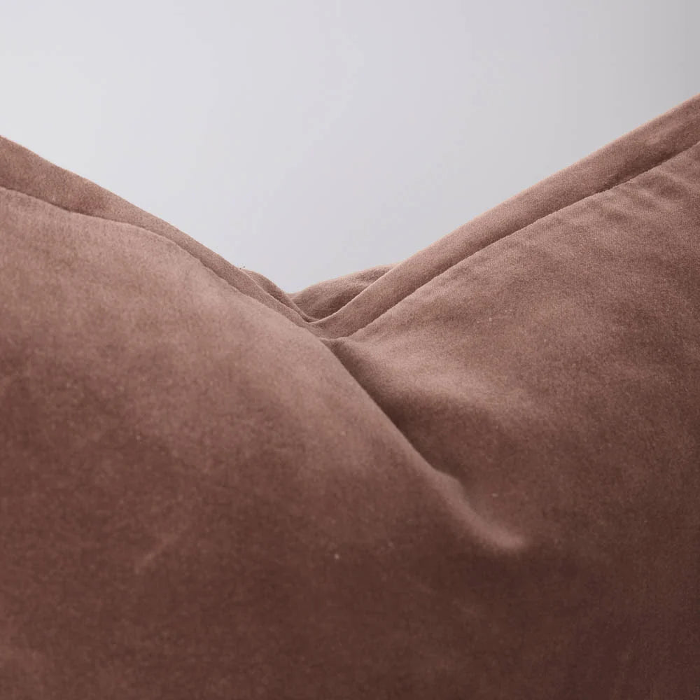 Close-up of a velvet clay coloured extra long lumbar cushion