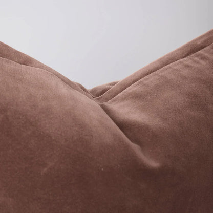 Close-up of a velvet clay coloured extra long lumbar cushion