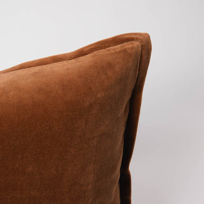 Brown pillow on a light gray background