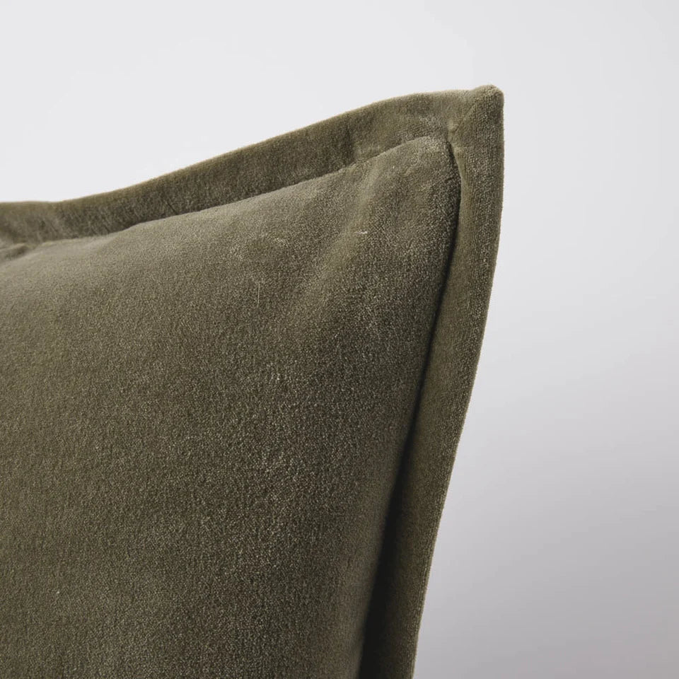 Close-up of a velvet olive green extra long lumbar cushion