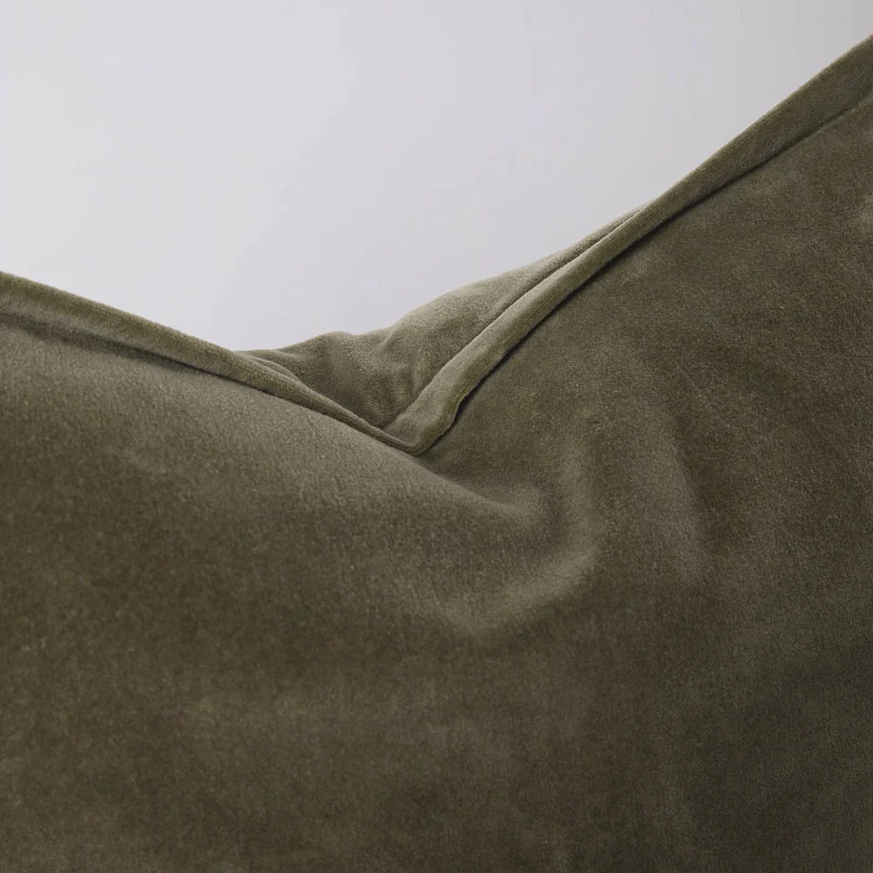 Close-up of a velvet olive green extra long lumbar cushion
