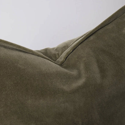 Close-up of a velvet olive green extra long lumbar cushion