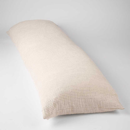 A long, rectangular body pillow in a textured, ribbed fabric with a warm cream or light beige color, photographed on a neutral light gray background.