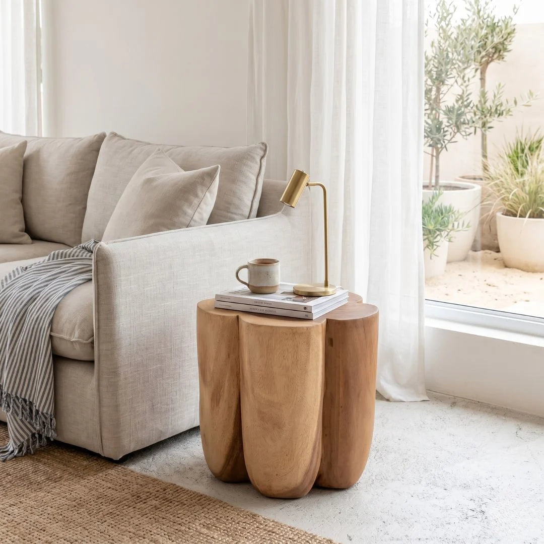Beige sofa with a wooden side table in a bright living room