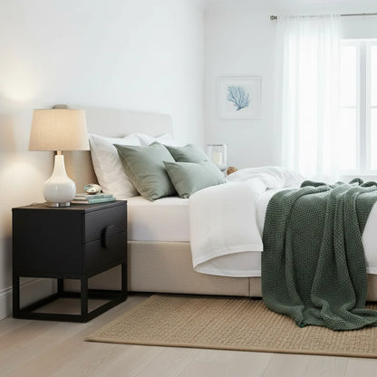 Modern bedroom with a bed, nightstand, and lamp.