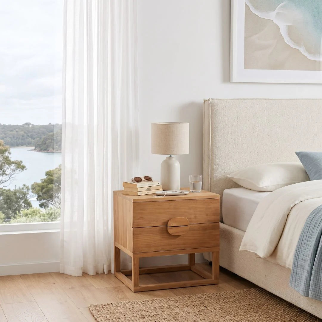Teak Bedside table styled next to a bed in a modern bedroom