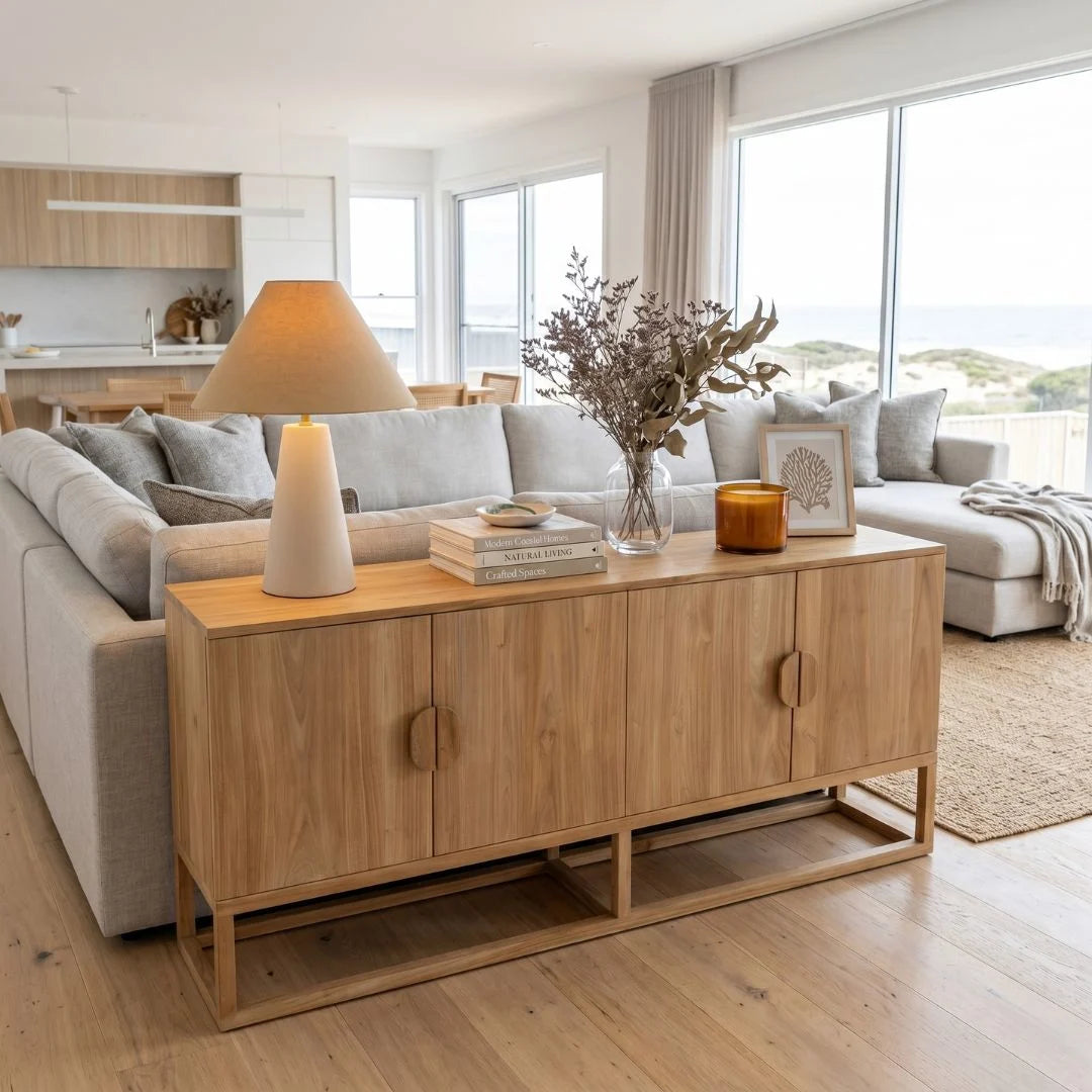 Modern living room with wooden sideboard, mirror, and decor items.