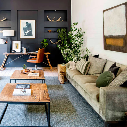 Modern living room with gray sofa, wooden coffee table, and decorative elements.