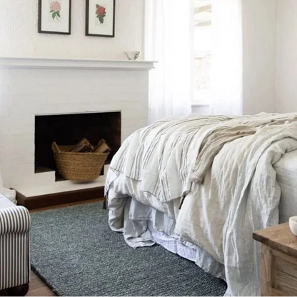 Cozy bedroom with a fireplace, bed, and decorative elements.