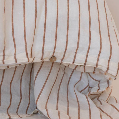 Close-up of a striped duvet cover with brown and white lines.