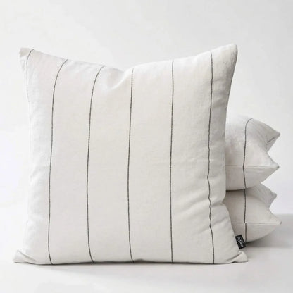 White pillow with black stripes on a white background