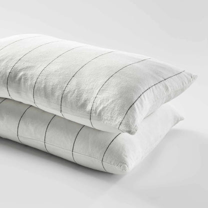 Two gray pillows with striped pattern on a light gray background
