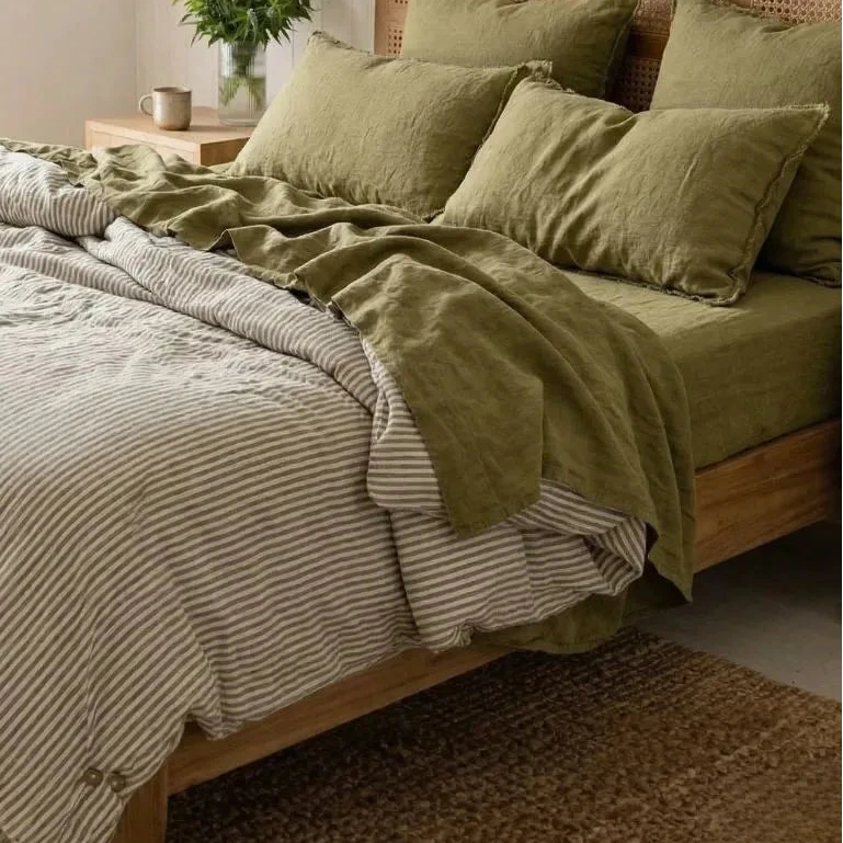 Bedroom with a wooden bed and olive green bedding