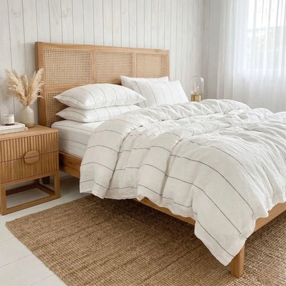 Bedroom with a wooden bed and striped bedding