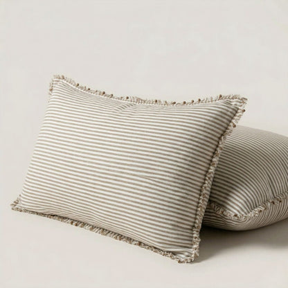 Two striped pillows with frayed edges on a light background