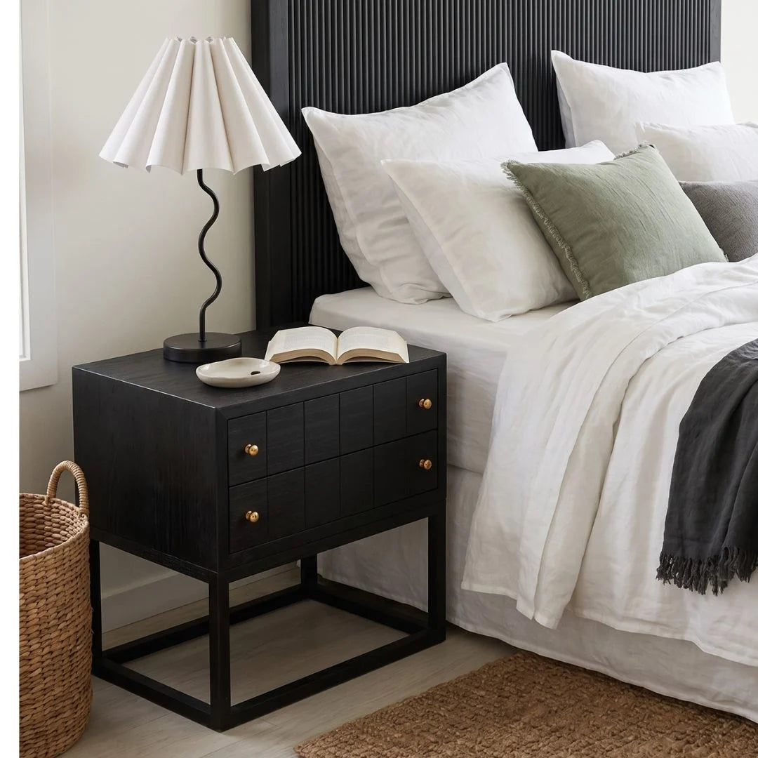 Black bedside table featured in a modern bedroom setting